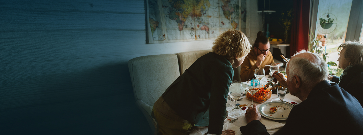 Two women reviewing paperwork together at a kitchen table